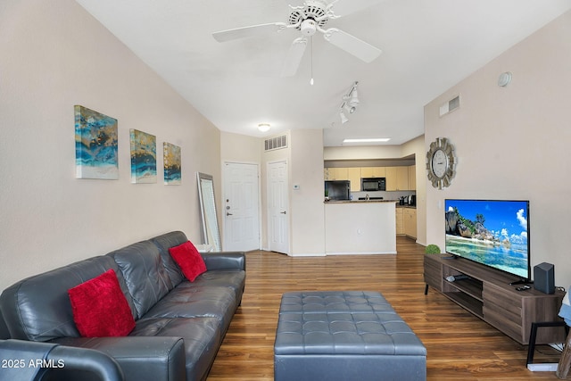 living room featuring ceiling fan, visible vents, track lighting, and wood finished floors