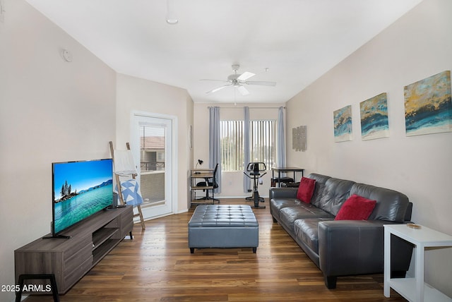 living area with baseboards, ceiling fan, and wood finished floors