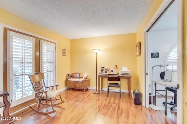 sitting room featuring hardwood / wood-style flooring and a textured ceiling