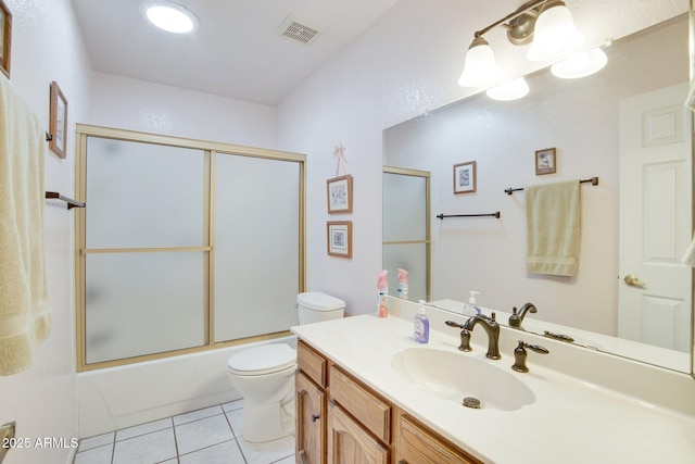 full bathroom featuring tile patterned flooring, vanity, combined bath / shower with glass door, and toilet