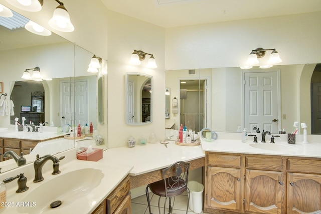 bathroom with tile patterned flooring, vanity, and a shower with door