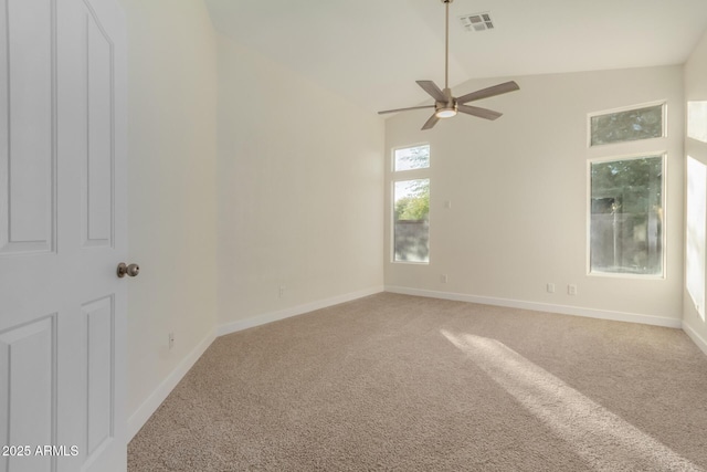 carpeted empty room with ceiling fan and lofted ceiling