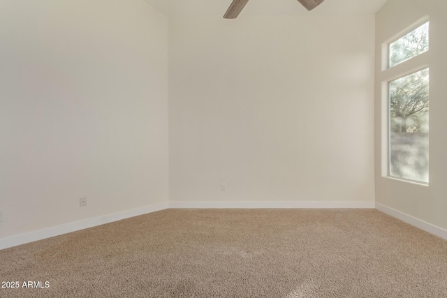 empty room featuring ceiling fan and carpet