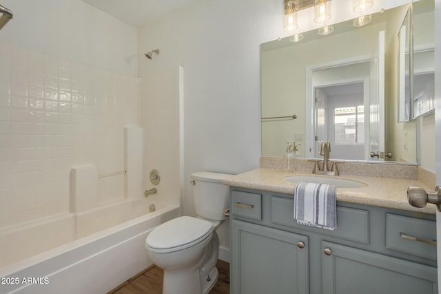 full bathroom featuring hardwood / wood-style flooring, vanity, toilet, and tub / shower combination