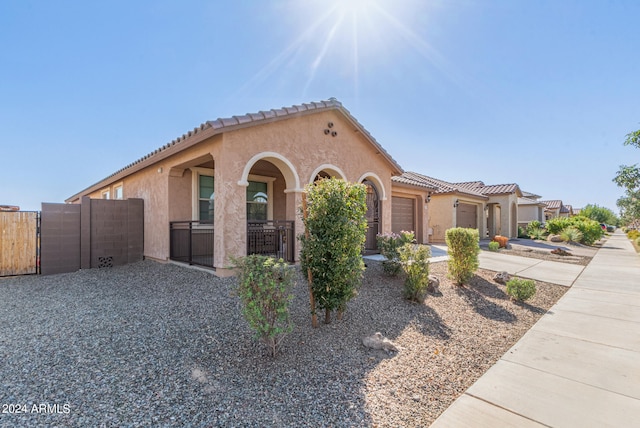 mediterranean / spanish-style home with a garage