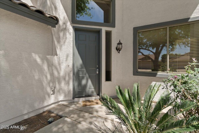 property entrance with stucco siding