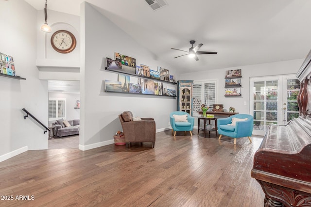 living area featuring a ceiling fan, wood finished floors, visible vents, baseboards, and french doors