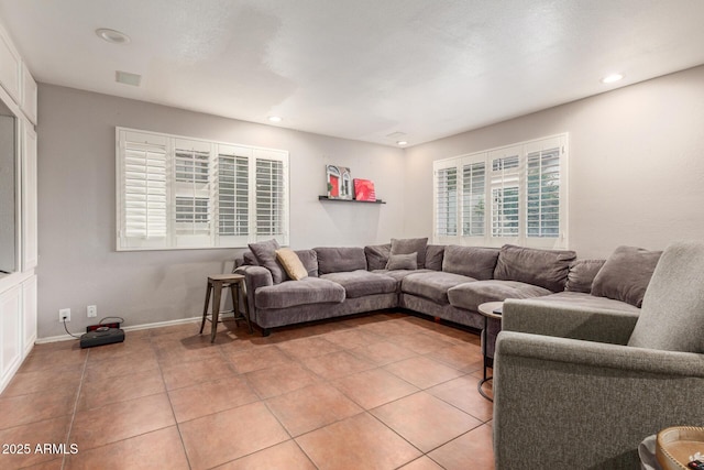 living room with light tile patterned floors, visible vents, baseboards, and recessed lighting