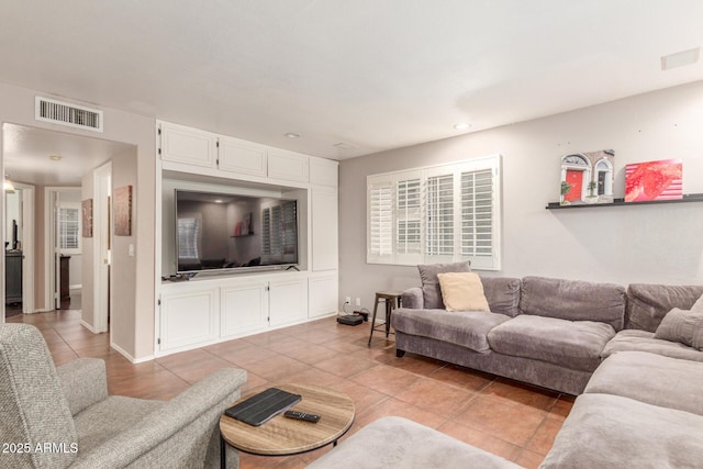 living area featuring light tile patterned floors, visible vents, baseboards, and recessed lighting