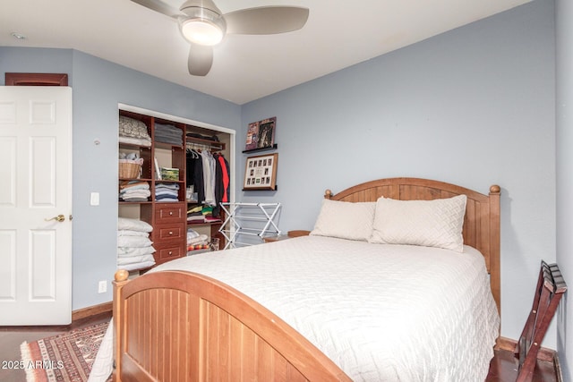 bedroom featuring a closet, baseboards, ceiling fan, and wood finished floors