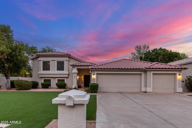 mediterranean / spanish-style house with a tile roof, a lawn, stucco siding, a garage, and driveway