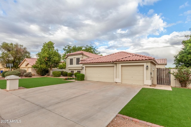 mediterranean / spanish home with stucco siding, a front lawn, concrete driveway, a garage, and a tiled roof