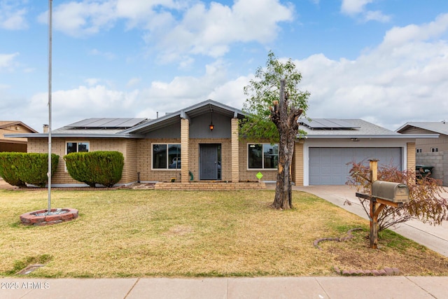 mid-century home with a garage, solar panels, brick siding, driveway, and a front yard