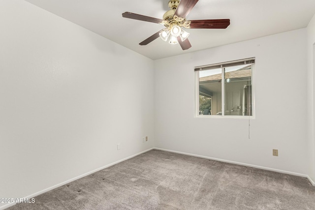 empty room with carpet, ceiling fan, and baseboards