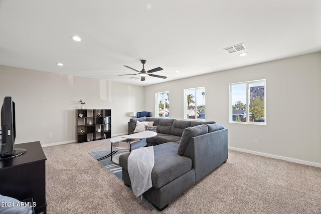 carpeted living room featuring ceiling fan