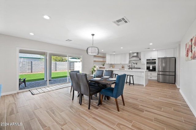 dining room featuring sink and an inviting chandelier