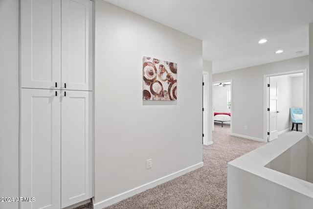 hallway with light colored carpet