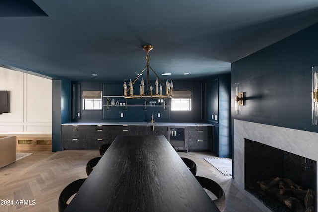 kitchen with a wealth of natural light, sink, light parquet floors, and decorative light fixtures