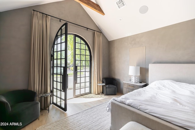 bedroom with vaulted ceiling with beams, light hardwood / wood-style flooring, and multiple windows