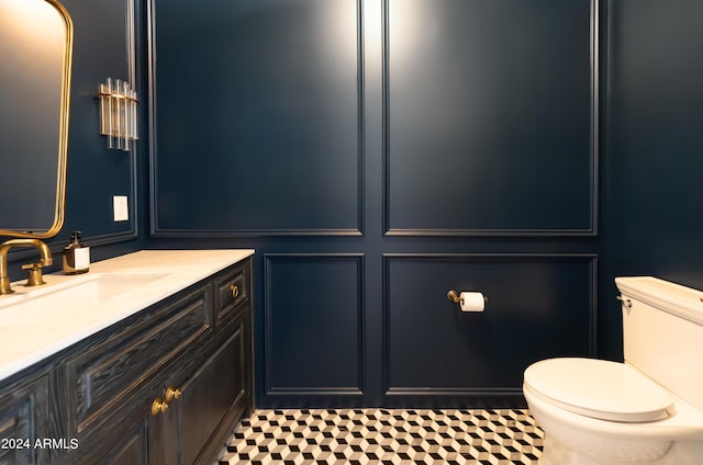 bathroom featuring tile patterned flooring, vanity, and toilet