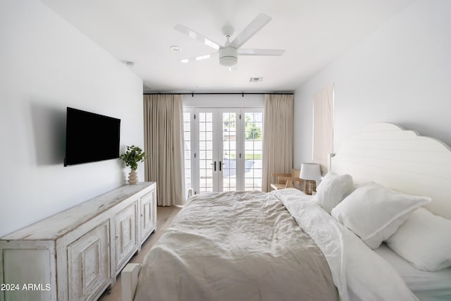 bedroom with access to exterior, french doors, and ceiling fan