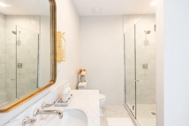 bathroom with tile patterned flooring, vanity, toilet, and walk in shower