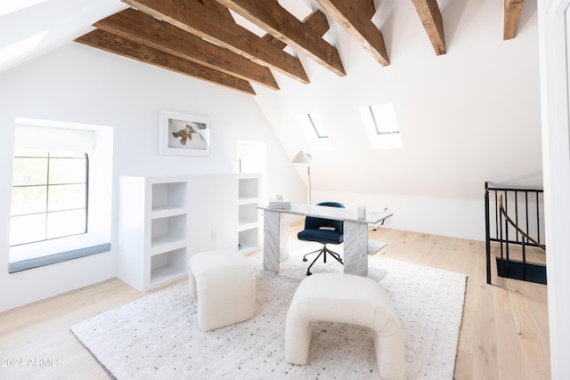 office area with lofted ceiling with skylight and light hardwood / wood-style floors