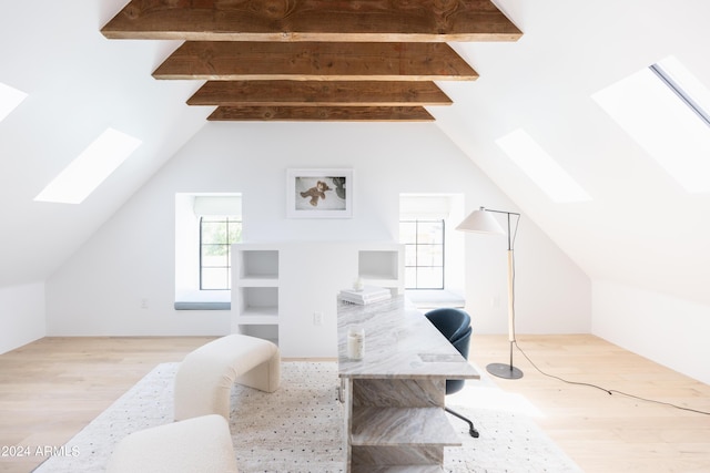 office area featuring light hardwood / wood-style floors and lofted ceiling with skylight