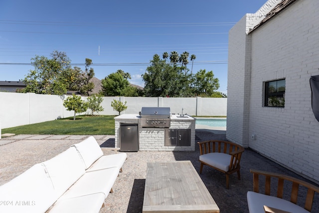 view of patio / terrace featuring area for grilling, sink, and grilling area