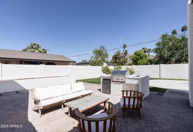 view of patio / terrace featuring outdoor lounge area, an outdoor kitchen, area for grilling, and sink