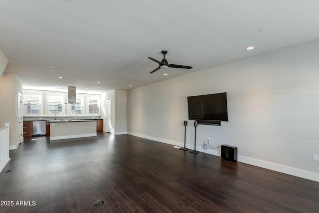 unfurnished living room featuring dark hardwood / wood-style floors and ceiling fan