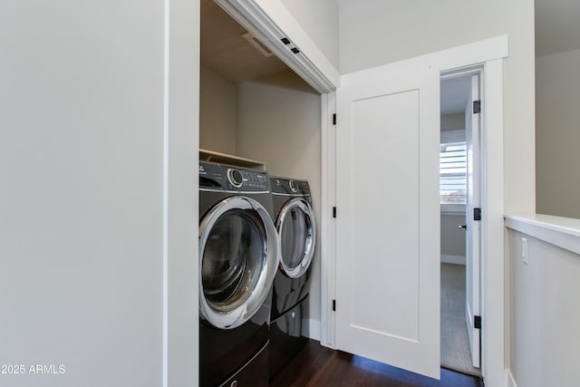 laundry area featuring dark wood-type flooring and independent washer and dryer