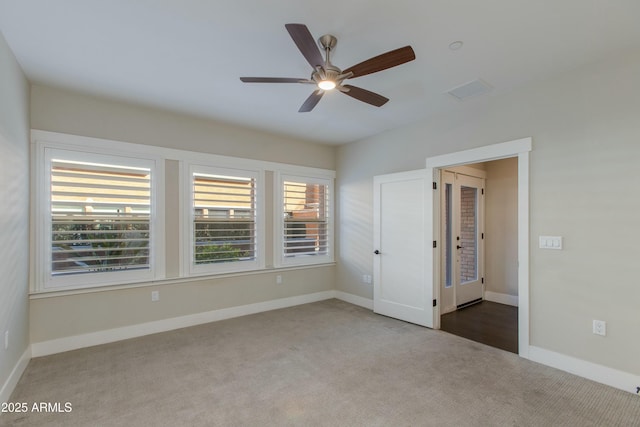 interior space featuring carpet floors and ceiling fan