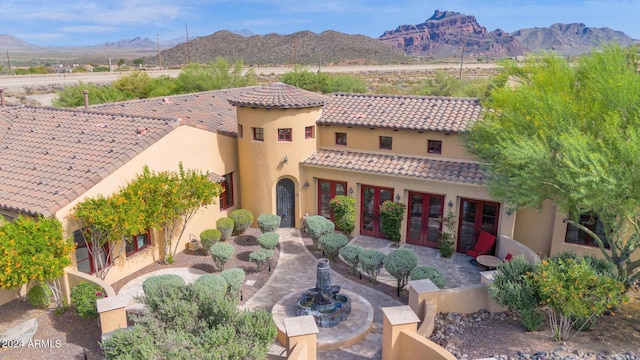 rear view of property featuring a mountain view and french doors