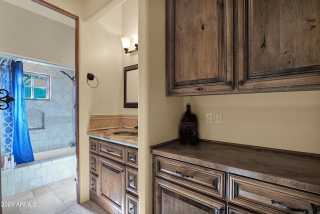 bathroom featuring a shower with shower curtain, vanity, and tile patterned flooring