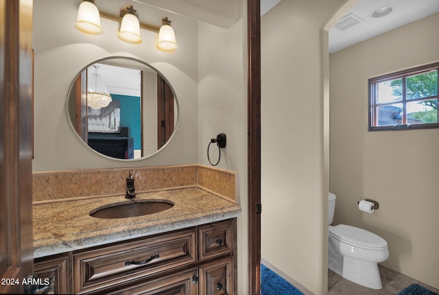 bathroom with tile patterned floors, vanity, and toilet