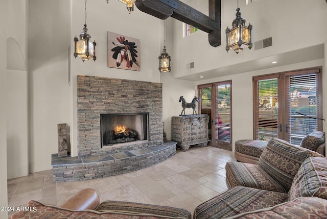 living room with a fireplace and a towering ceiling