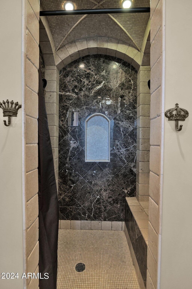 bathroom featuring lofted ceiling