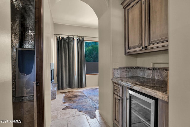 kitchen featuring stone counters and wine cooler