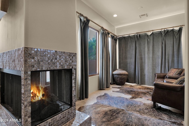 living room with a tiled fireplace