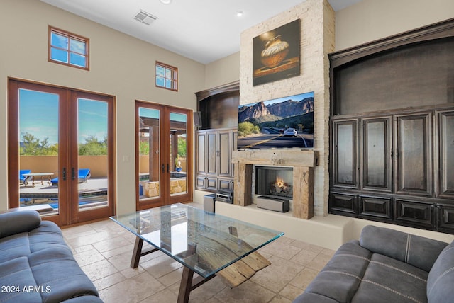 living room featuring a fireplace and french doors