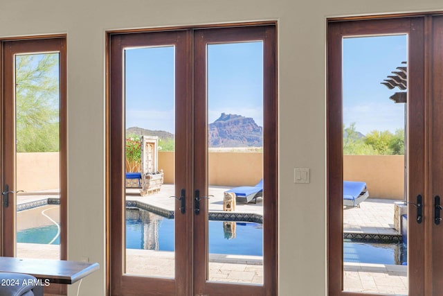 doorway with french doors and a healthy amount of sunlight