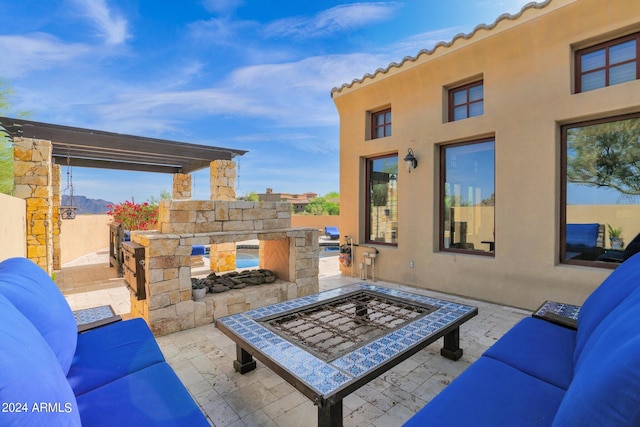 view of patio / terrace with an outdoor living space with a fireplace