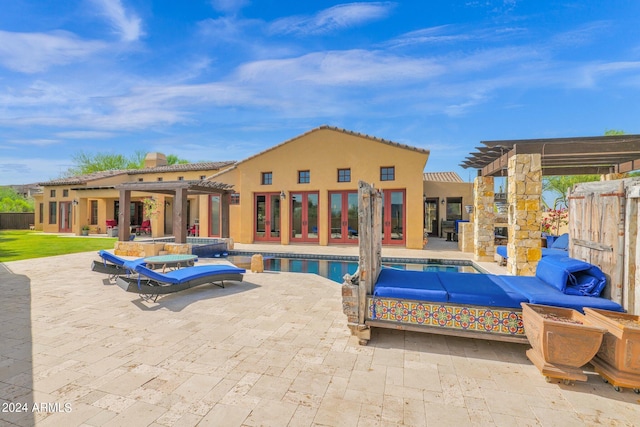 view of swimming pool with outdoor lounge area, french doors, and a patio