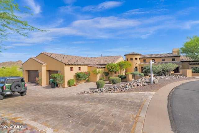 mediterranean / spanish home featuring a garage