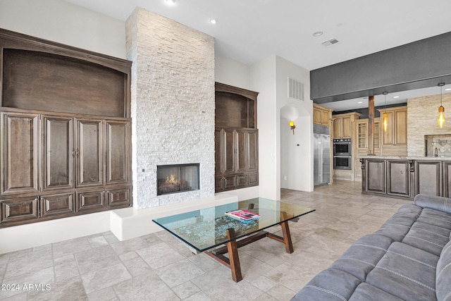 living room with a stone fireplace