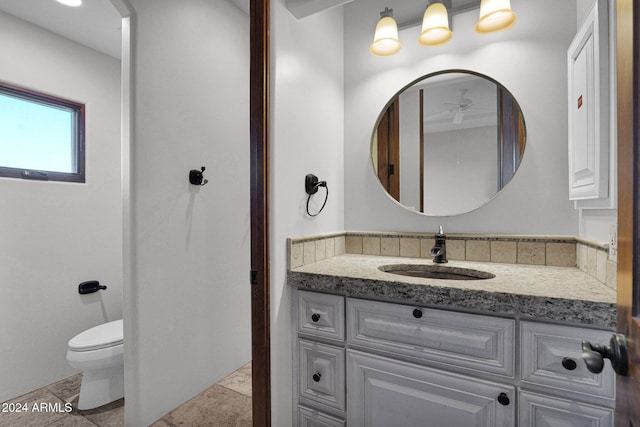 bathroom featuring tile patterned floors, vanity, and toilet