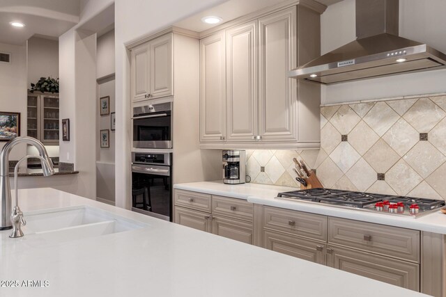3205 S Ponderosa Dr, Gold Canyon, AZ 85118 - kitchen featuring a sink, wall chimney exhaust hood, backsplash, and stainless steel appliances