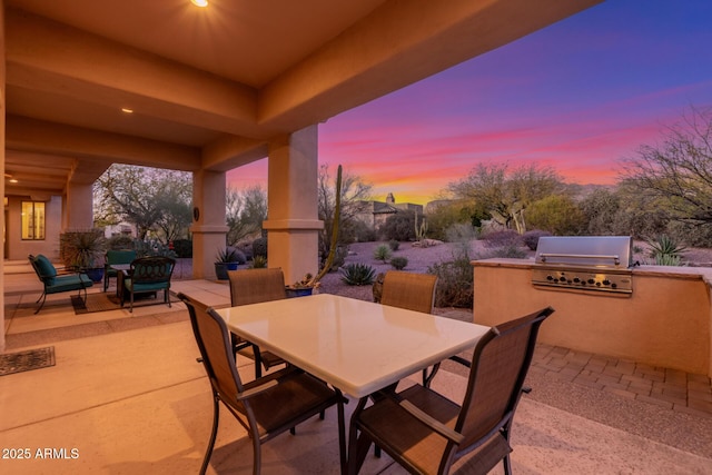 3205 S Ponderosa Dr, Gold Canyon, AZ 85118 - patio terrace at dusk featuring a grill, outdoor dining space, an outdoor living space, and exterior kitchen