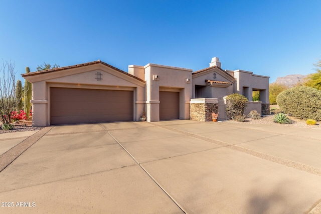 3205 S Ponderosa Dr, Gold Canyon, AZ 85118 - pueblo revival-style home featuring a tiled roof, an attached garage, driveway, and stucco siding